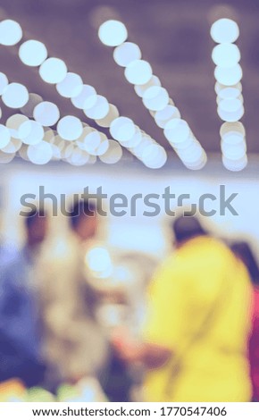 Vintage tone abstract blurred image of  Shopping mall or Exhibition hall  with bokeh  for background usage.