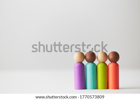 Wooden figurines concept. One group of different skin colour people standing together, mixed skin colour in one group. Social and racial issues non existent. Kids wooden toys. Royalty-Free Stock Photo #1770573809
