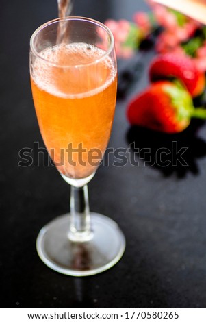 A glass of rose wine with strawberries