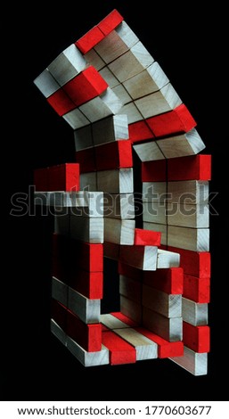 Abstract construction with colored wooden bricks, black background.
