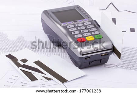 Business still-life of tables, payment terminal, credit Cards