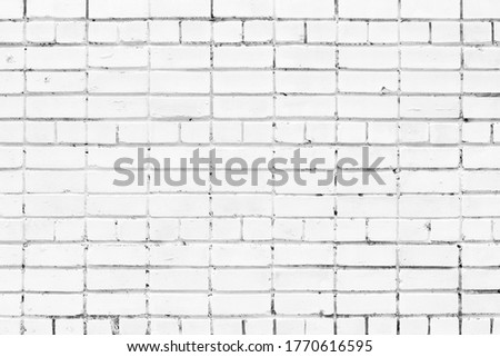 Whitewashed shabby brick wall texture. White painted old brickwork grungy background