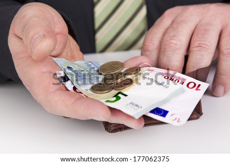 Businessman showing the contents of his wallet
