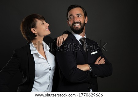 a man and a woman in suits isolated on gray background