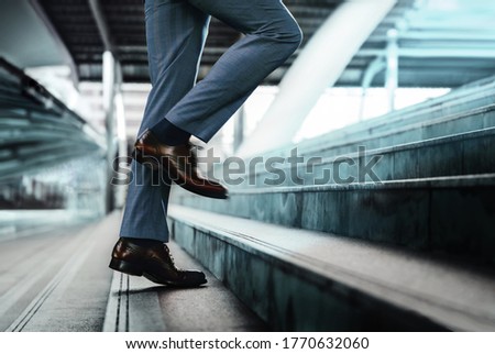 Motivation and challenging Concept. Steps Forward into a Success. Low Section of Businessman Walking Up on Staircase Royalty-Free Stock Photo #1770632060