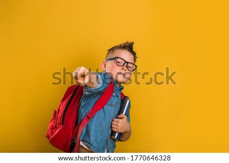 boy pointing at you. Funny little school kid ready to educate. Back to school