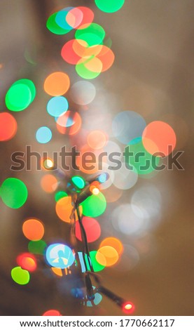 Christmas lights. Blurred background. Colored circles from the led lamp. Festive texture.