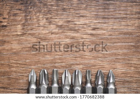 Close up photo of Drill bit set 8 type on wooden background
