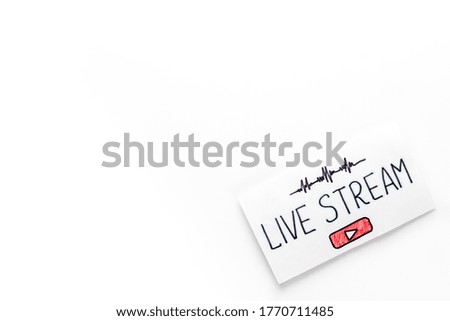 Live streaming concept - words on paper tablet on white top view