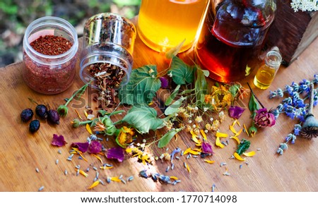 dry ingredients for essential oil with glass bottles on the wood table