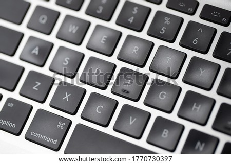 close up modern laptop, stylish computer keyboard the area. The flat trackpad can be seen in the frame. focus notebook characters.