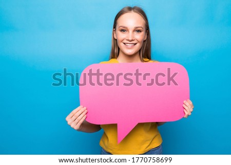 Young woman holding a speech bubble on blue background