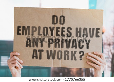 The question " Do employees have any privacy at work? " on a banner in men's hand with blurred background. Private information. Workplace. Privacy. Employer. Rules. Security