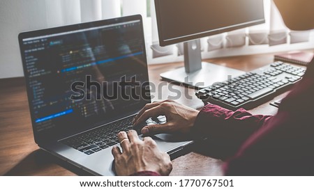 Programmer working in a software development and coding technologies. Website design. Technology concept. Royalty-Free Stock Photo #1770767501