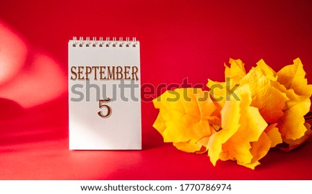 Calendar with the text October 5 on a red background and with a maple leaf