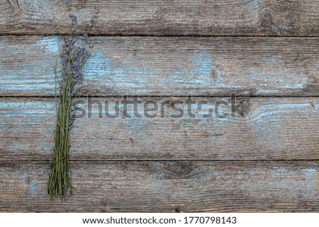 Lavender on a rustic wooden table closeup with copy space background.