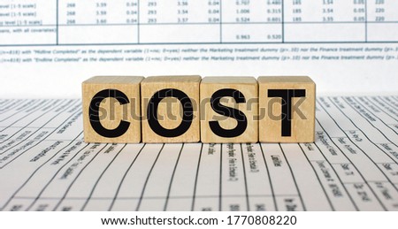 Word Cost made with wood building blocks