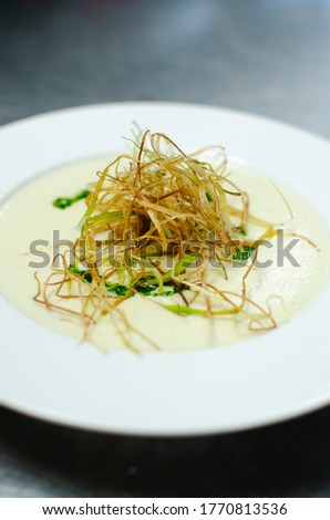 Delicious gourmet potato soup in bowls. Tasty soup plated up in bowls ready to eat.
