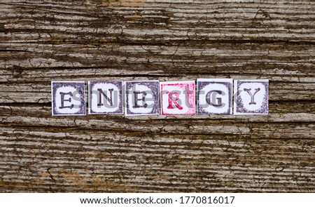 Energy word, ink stamp letters on a wooden background