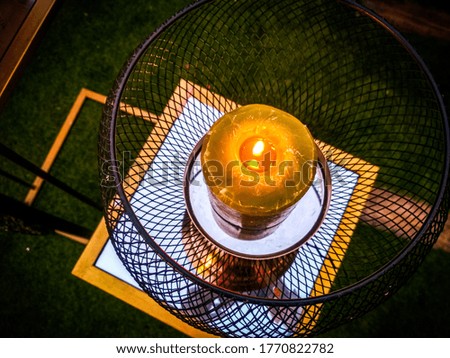 picture of mirror and candle, used for decoration in a restaurant and attracting people towards it.