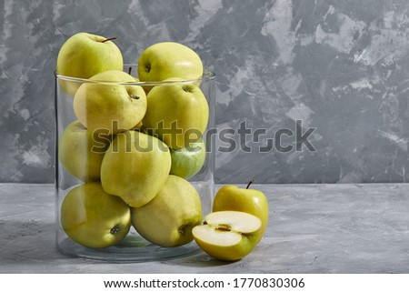 yellow apples on the table. Top view with copy space on gray stone background.