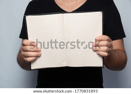 man holding an empty notebook