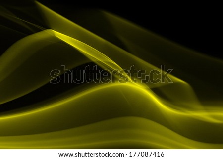 Yellow abstract smoke on black background - macro photo
