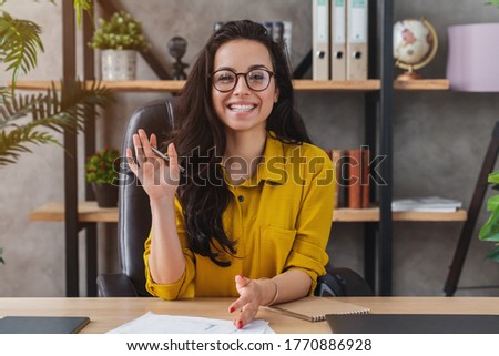 Happy millennial woman wave talk on webcam or having conversation for job video call Royalty-Free Stock Photo #1770886928