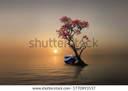 a boat with a tree in  the sunset