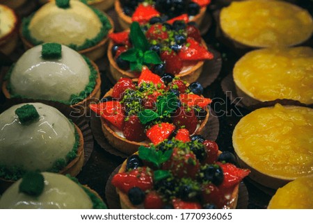 Vintage photography style of berries pastry puff dessert in row, selected focus.