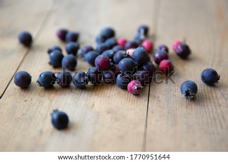 honeysuckle berries on a natural wooden background