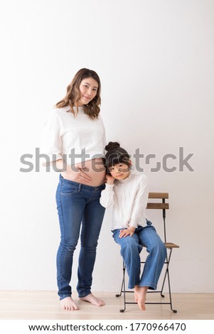Pregnant woman and girl portrait