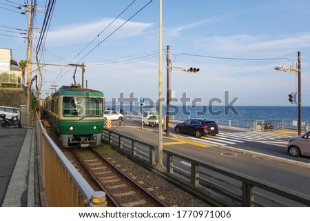 Enoden trains running by the sea Royalty-Free Stock Photo #1770971006