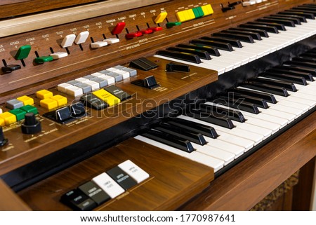 Close up view of the instrument button and instrument key on old electric organ