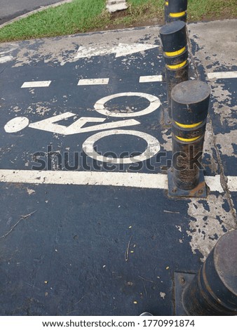 Pavement bicycle sign on road side