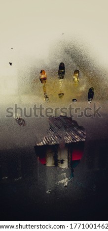 Picture of a palm print on a misty glass window 
