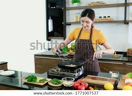 Asian lovely women present fresh food. Shot housewife showing cooking steak and vegetable in kitchen in house to take picture for sell food box online. Work from home  Stay at home  covid19 concept 