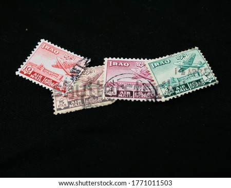 Macro photo of letter stapms. Translation of Arabic words: Iraq Mail￼