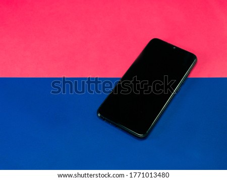 
smartphone on bicolor background, blue and pink
