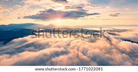 Flying above the clouds on drone. Panoramic morning view of Carpathian mountains with Homiak mountain on background. Fabulous sunrise on Ukraine, Europe. Beauty of nature concept background.
 Royalty-Free Stock Photo #1771022081
