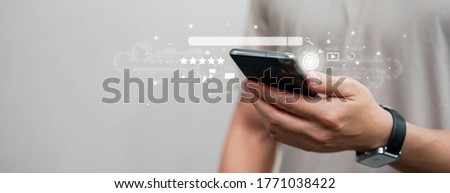close up man hand using smartphone to use search engine optimization (SEO) tools for finding customer or promote and advertise about content online for marketing technology and business concept