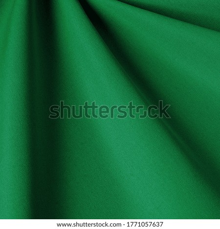 Plain fabric green grass background. Fabric with natural texture, Cloth backdrop.
