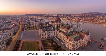 Panoramic aerial drone shot of Dome of Hungarian Parliament at dawn before sunrise in Budapest morning