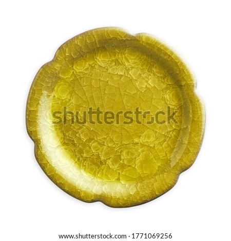 Empty yellow plate with cracked pattern, isolated on white background with clipping path, Top view                               