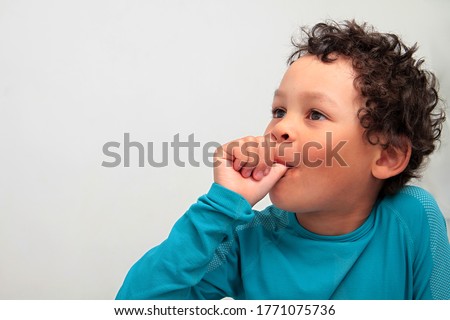 little boy sucking thumb on white background with people stock image stock photo Royalty-Free Stock Photo #1771075736