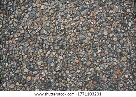 Macro photo of crushed stone and gravel on the ground. Texture background white gray stones on a black earth background. Image of broken stones