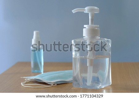 Alcohol for disinfecting in clear gel form in plastic bottles or glass bottles with a white pump. Installed in rooms in the building to wash hands and clean and also have a mask to prevent Covid-19.