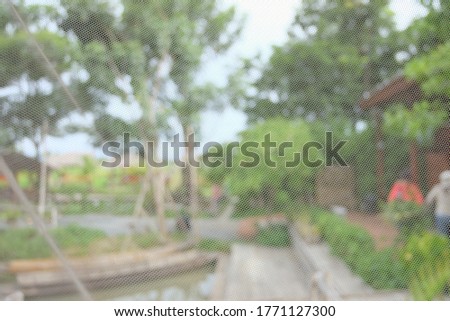 blurred white nylon net covered in indoor space and decoration a place with green garden background