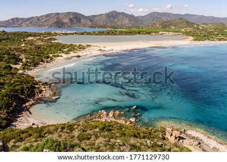 view from the hill down at the beach and turquoise Mediterranean sea at the bright summer day 