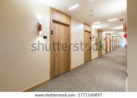 Interior of a long hotel corridor doorway Royalty-Free Stock Photo #1771160897